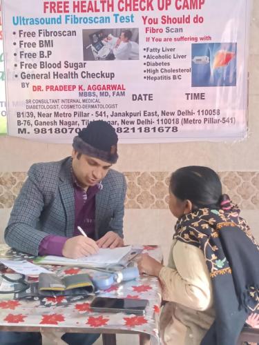 A patient consulting Dr. Pradeep at free medical camp.