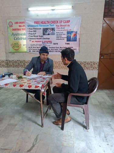 A patient consulting Dr. Pradeep at free medical camp.